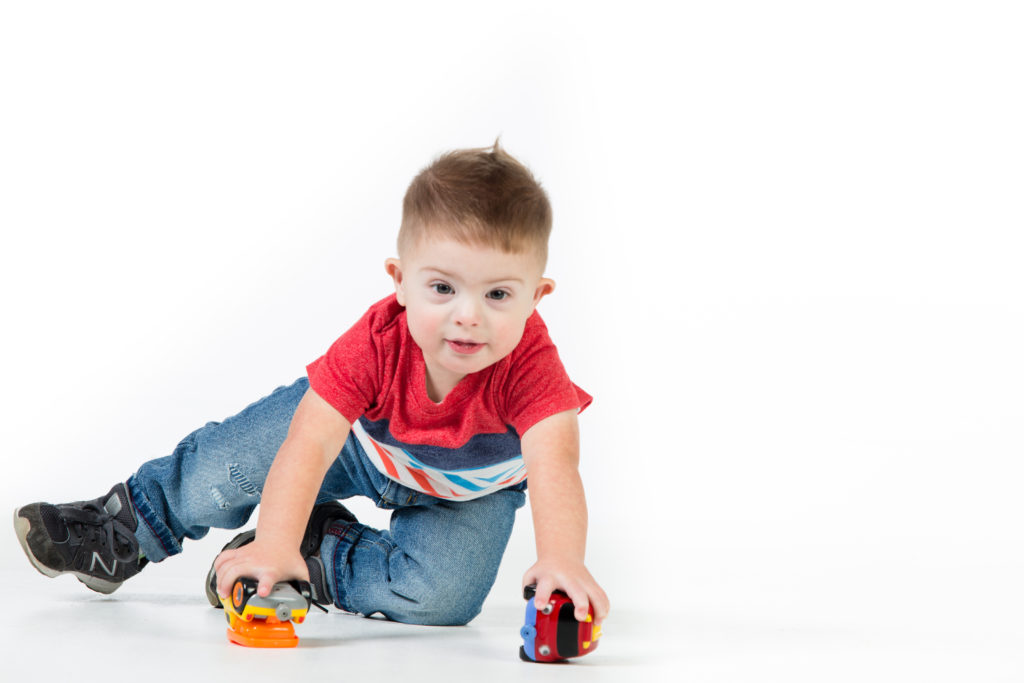 Toddler boy with toy trucks